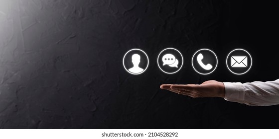 Businessman hand holding,pressing on icon phone, mail, telephone,message,post and person,user. Customer service call center contact us concept.Banner,copy space.Contact Methods - Shutterstock ID 2104528292
