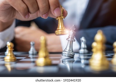 businessman hand moving gold Chess King figure and Checkmate opponent during chessboard competition. Strategy, Success, management, business planning, disruption and leadership concept - Shutterstock ID 1932441920