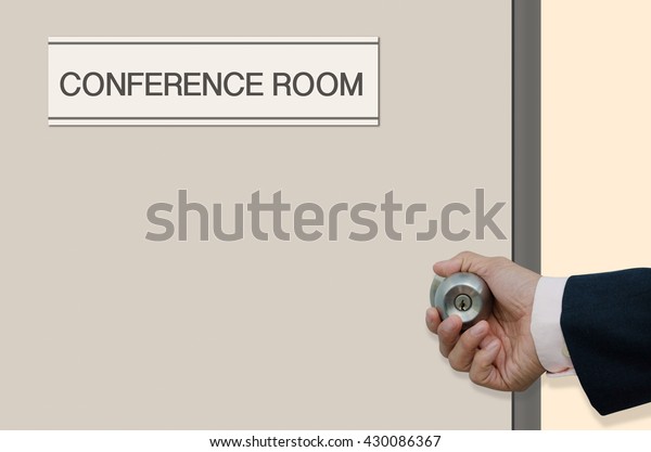 Businessman hand opening the door of room with\
label \