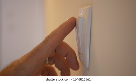 Businessman Hand Opening The Light In Interior Office Room From The Wall Switch