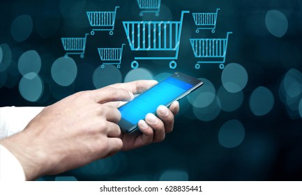 Businessman hand phone  and  shopping basket icon over bokeh background - Shutterstock ID 628835441