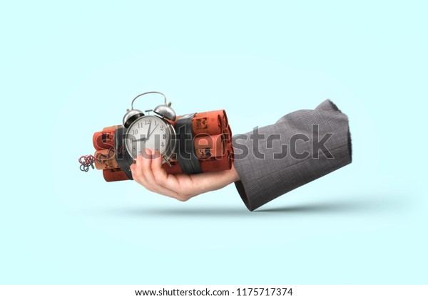 Businessman hand\
with pile of dynamite an\
detonator