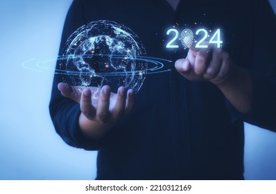 Businessman hand pointing to 2024 to start business in the new year. Concept Technological growth, economy, finance, stock market, data communication.