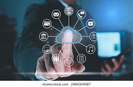 Businessman hand pointing at cloud computing hologram with various icons and connect to cloud data technology on global network connection technology. Cloud computing and storage server concept.
