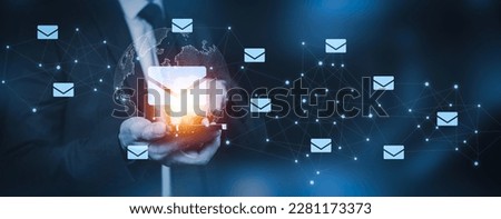 Businessman hand pressing smartphone for sending the e-mail from the laptop computer, Email and SMS marketing concept. Scheme of direct sales in business. List of clients for mailing.