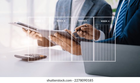 Businessman hand Project manager working and update tasks and Gantt chart scheduling virtual diagram.with smart phone, tablet and laptop in office. - Shutterstock ID 2278090185