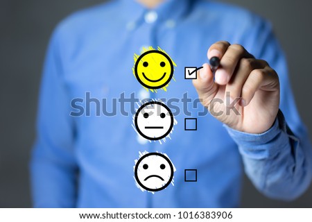 Businessman hand putting check mark a checkbox on excellent smiley face rating for a satisfaction survey, Customer experience concept.