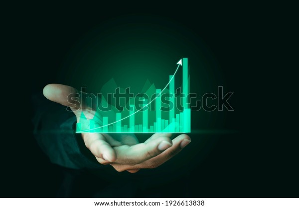Businessman hand show Stock chart\
showing rising stock sign with graph indicator. Interest rate\
financial and mortgage rates concept. Double Exposure\
Image.