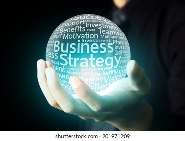 Businessman Hand Showing Business Strategy Word In Crystal Ball