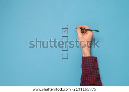 businessman hand sign check mark box with a pen, view from above