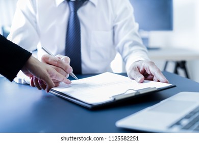 Businessman hand signing contract.
