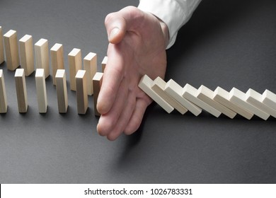 Businessman Hand Stop Domino Continuous Tipping Or Risk. Strategy In Business.