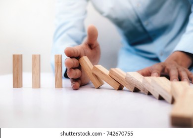 Businessman Hand Stop Dominoes Continuous Toppled Or Risk With Copyspace. Business Risk, Strategy And Planing Concept Idea.