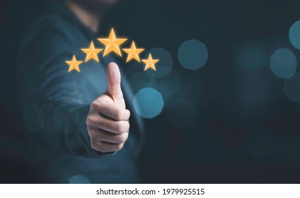 Businessman hand thumb rise up with yellow stars for customer satisfaction and product service evaluation concept. 