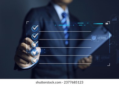 Businessman hand ticking check mark by pen on box to approve or answer the question on virtual dashboard - Shutterstock ID 2377685123