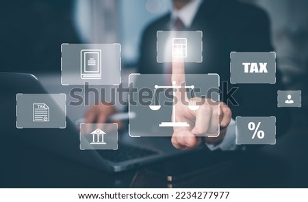 Businessman hand touch bar TAX, Refund tax of duty taxation business, graph labor law attorney legal business,graphs and chart being demonstrated on the screen media, tablet and selecting tax refund.