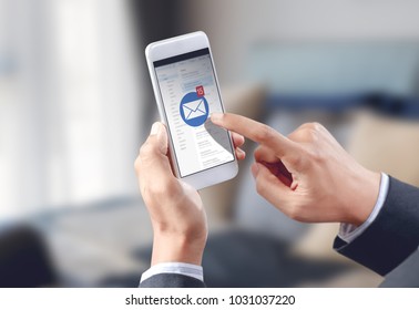 businessman hand touch email envelope icon on mobile screen - Shutterstock ID 1031037220
