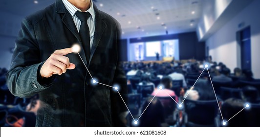 Businessman Hand Touch Virtual Chart Business, Abstract Blurred Of Conference Hall Or Seminar Room With Attendee Background, Double Exposure.