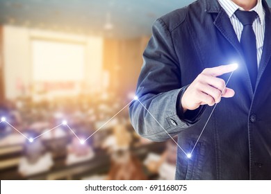 Businessman Hand Touch Virtual Chart Business, Abstract Blurred Of Conference Hall Or Seminar Room With Attendee Background, Double Exposure.