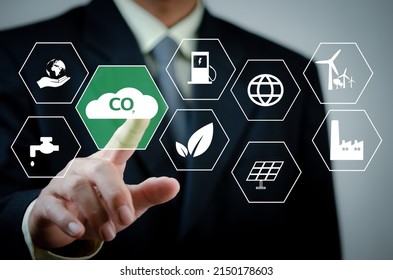 Businessman Hand Touches Global Warming Renewable Energya Virtual Screen. Reduce CO2 Emissions. Sustainable Business Development Concept .