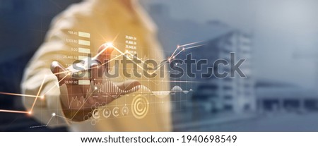 Businessman hand touching and analysing banking and investment growth graph to develop smart financial decision for business plan strategy in expand business and increase sale profit.
