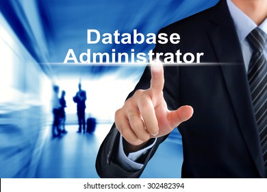 Businessman Hand Touching Database Administrator (or DBA) Text On Virtual Screen