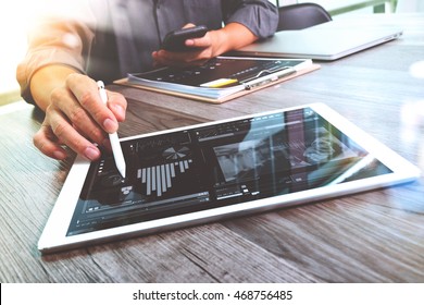 Businessman hand touching digital tablet.Photo finance manager working new Investment project office.Using new technology device.Graphic icons.Strategy business stock exchanges interface 
