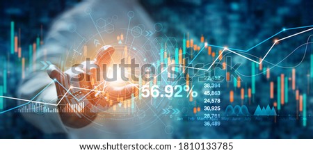 Businessman hand touching of forex graph growth interface and financial data analysis. Stock market on blue background.