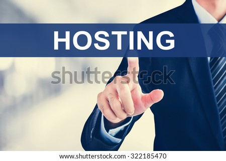 Businessman hand touching HOSTING sign on virtual scr een