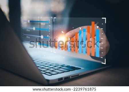 businessman hand type on the laptop of company profit with colleagues partner explain with virtual dashboard statistic chart stock infographic, graphs, cryptocurrency, and new trading platforms