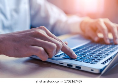 Businessman hand typing on computer keyboard of a laptop computer in office. Business and finance concept. - Shutterstock ID 1702167487