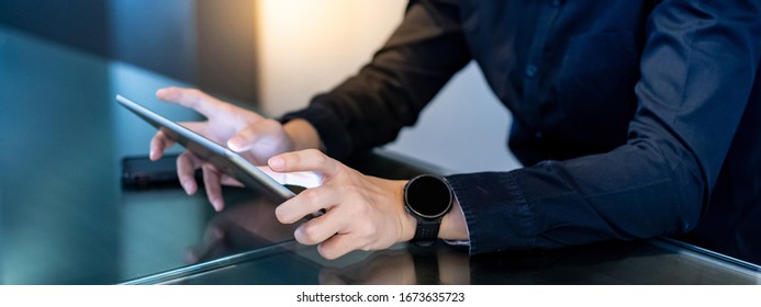 Businessman Hand Using Digital Tablet In Office Meeting Room. Male Entrepreneur Reading News On Social Media App. Online Marketing And Big Data Technology For E-commerce Business. 