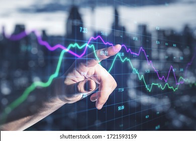 Businessman hand using falling stock chart on screen interface with index. Trade and finance concept. Double exposure