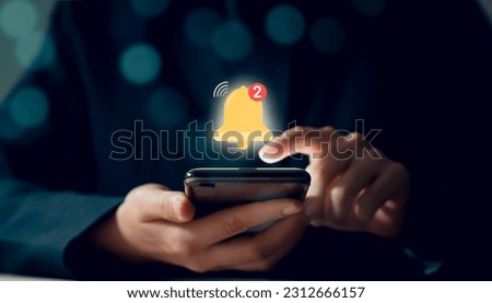 Businessman hand using smartphone with showing the bell icon and notifications of new messages on application.