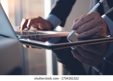 Businessman Hand Using Stylus Pen Signing Contract On Digital Tablet While Working On Laptop Computer In Modern Office, Electronic Signature. Business Man Taking Note On Touchpad, Business Concept