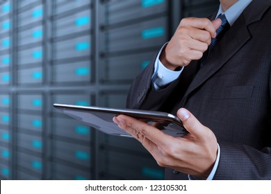 businessman hand using tablet computer and server room background