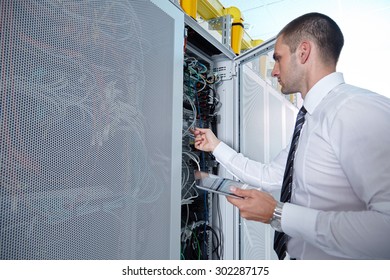 Businessman Hand Using Tablet Computer In Modern  Server Room