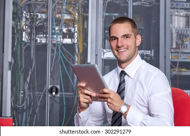 Businessman Hand Using Tablet Computer In Modern Server Room