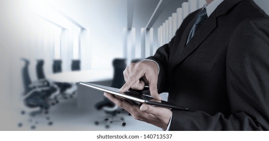 Businessman Hand Working With A Digital Tablet On Meeting Room Background