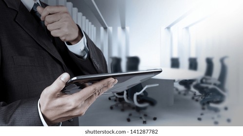 Businessman Hand Working With A Digital Tablet On Meeting Room Background