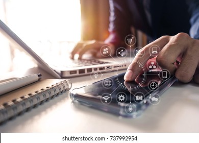 businessman hand working with finances about cost and calculator and laptop with tablet and smartphone on with desk in modern office in morning light.
