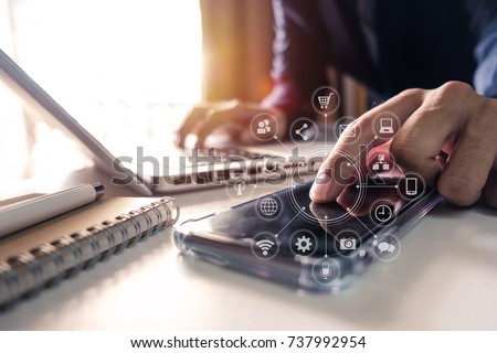 businessman hand working with finances about cost and calculator and laptop with tablet and smartphone on with desk in modern office in morning light.
