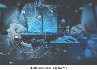 businessman hand working with modern digital tablet computer in modern office with virtual icon diagram - Powered by Shutterstock