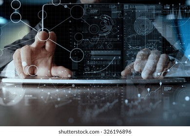 businessman hand working on laptop computer with digital layer business strategy and social media diagram on wooden desk   - Powered by Shutterstock