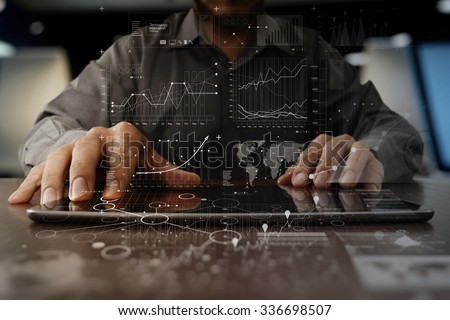 businessman hand working on laptop computer with digital layer business strategy and social media diagram on wooden desk