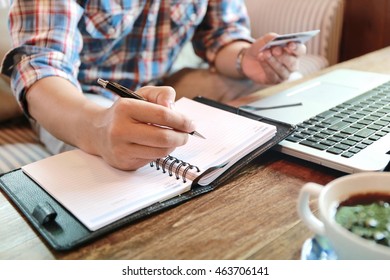 Businessman Hand Write Note On Paper With Hold Credit Card With Laptop, Hands Holding Credit Card And Using Laptop Shopping Online At Coffee Shop, Personal Loans  