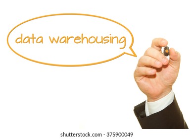 Businessman Hand Writing Data Warehousing Word On A Transparent Wipe Board.