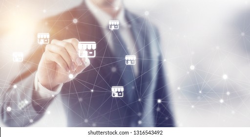 Businessman hand writing icon franchise marketing system in global network connection, copy space