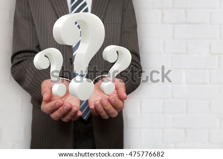 Businessman hands with 3 question marks. 