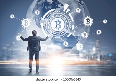 Businessman with hands in the air against a Bitcoin virtual interface hologram, a night city sky with the Earth in it. HUD. Toned image double exposure. Elements of this image furnished by NASA - Shutterstock ID 1080068843